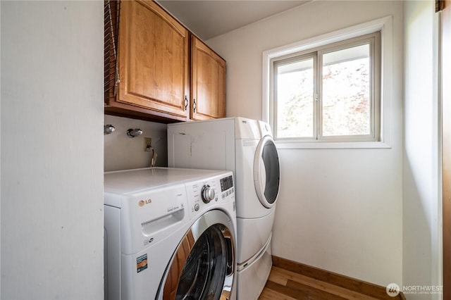 524 Carl Way, Aberdeen, WA 98520 - laundry room featuring cabinet space, washer and dryer, light wood-style flooring, and baseboards