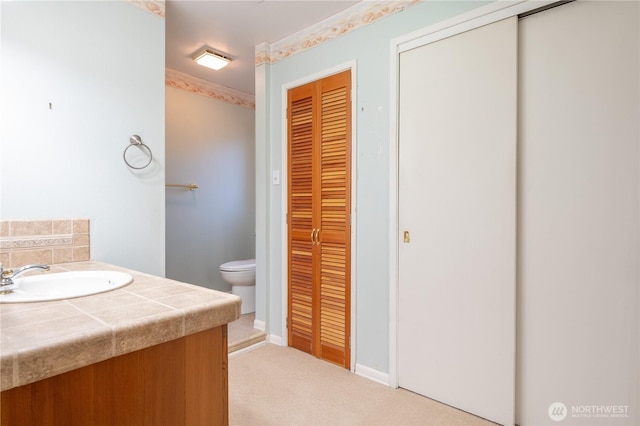 524 Carl Way, Aberdeen, WA 98520 - bathroom with toilet, a closet, vanity, and baseboards