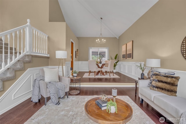 15525 66th Ave SE, Snohomish, WA 98296 - living area featuring a chandelier, wood finished floors, wainscoting, high vaulted ceiling, and a decorative wall