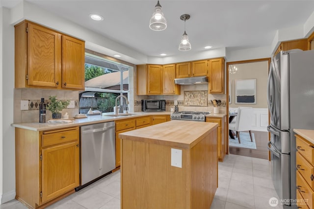 15525 66th Ave SE, Snohomish, WA 98296 - kitchen with stainless steel appliances, a sink, under cabinet range hood, wood counters, and a center island