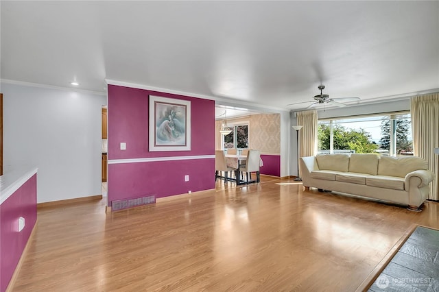 7351 32nd Ave SW, Seattle, WA 98126 - living area featuring ceiling fan, crown molding, baseboards, and light wood finished floors