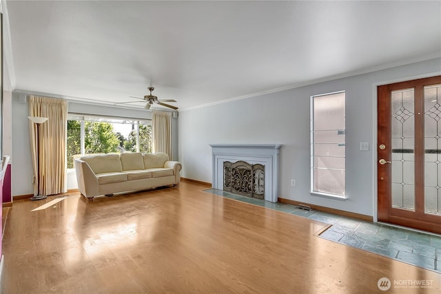 7351 32nd Ave SW, Seattle, WA 98126 - living area featuring crown molding, ceiling fan, baseboards, a fireplace with flush hearth, and wood finished floors