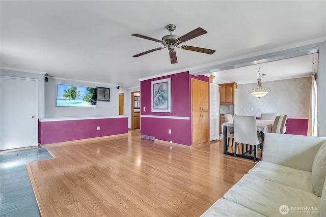 7351 32nd Ave SW, Seattle, WA 98126 - living room featuring ceiling fan, light wood-style floors, crown molding, and baseboards