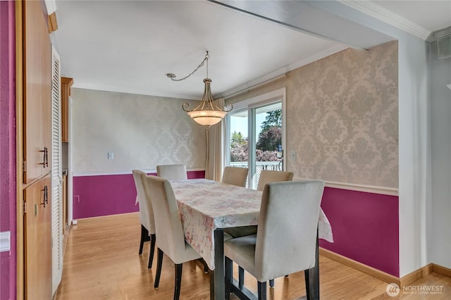 7351 32nd Ave SW, Seattle, WA 98126 - dining space featuring light wood-style floors, crown molding, wallpapered walls, and baseboards
