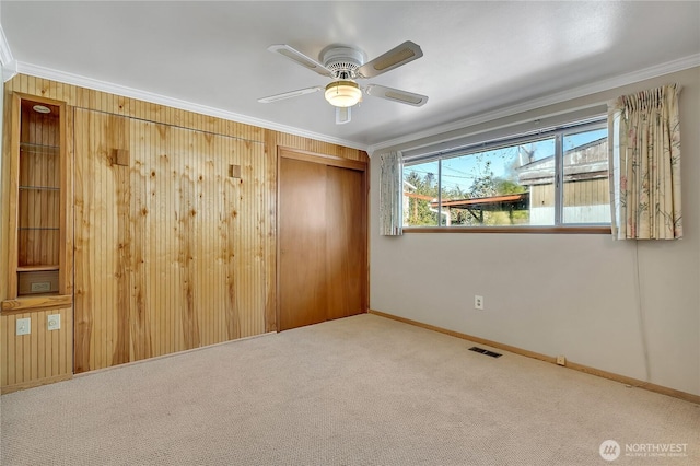 7351 32nd Ave SW, Seattle, WA 98126 - spare room with ornamental molding, baseboards, carpet flooring, and ceiling fan