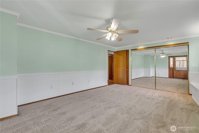 7351 32nd Ave SW, Seattle, WA 98126 - unfurnished bedroom with ornamental molding, a wainscoted wall, carpet, a closet, and ceiling fan