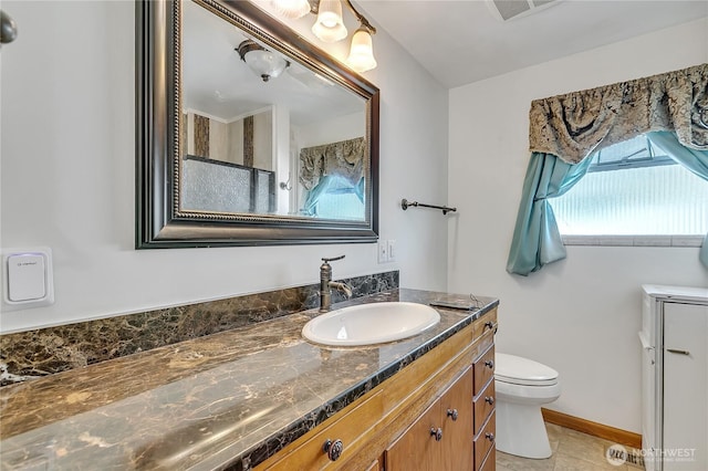 7351 32nd Ave SW, Seattle, WA 98126 - bathroom featuring vanity, toilet, tile patterned floors, and baseboards
