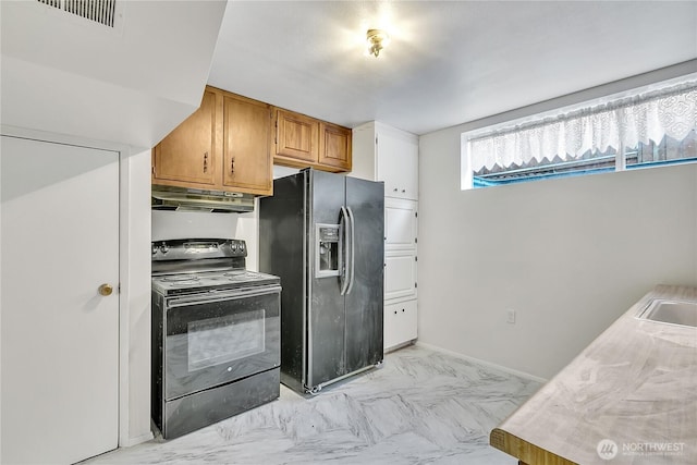 7351 32nd Ave SW, Seattle, WA 98126 - kitchen with black appliances, under cabinet range hood, light marble finish flooring, a sink, and brown cabinetry