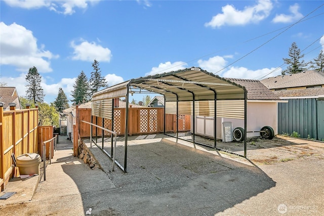 7351 32nd Ave SW, Seattle, WA 98126 - view of parking / parking lot featuring a detached carport, fence, and driveway