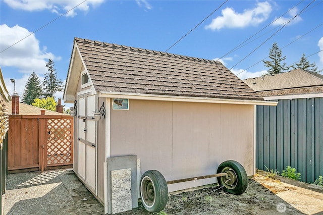 7351 32nd Ave SW, Seattle, WA 98126 - view of side of property with roof with shingles, fence, a gate, and an outdoor structure