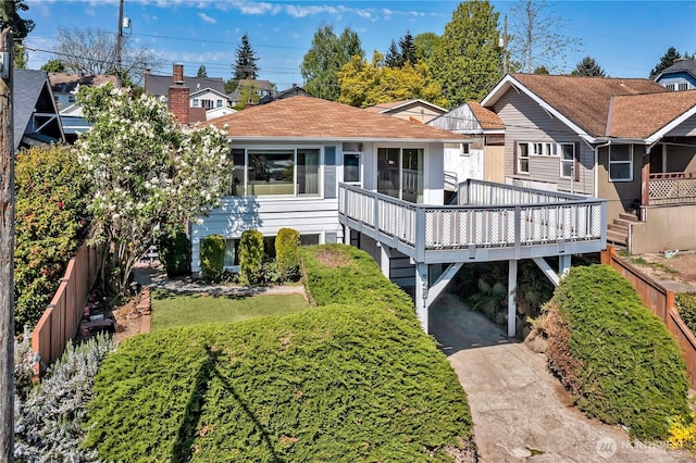 7351 32nd Ave SW, Seattle, WA 98126 - back of property with a wooden deck and roof with shingles
