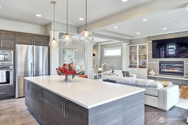3319 Burnett Ave N, Renton, WA 98056 - kitchen with stainless steel appliances, open floor plan, wood finished floors, recessed lighting, and light countertops