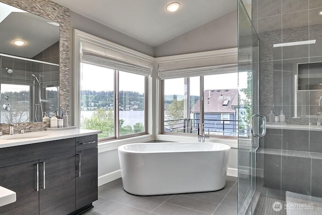 3319 Burnett Ave N, Renton, WA 98056 - full bathroom with vanity, a shower stall, a freestanding bath, tile patterned flooring, and vaulted ceiling