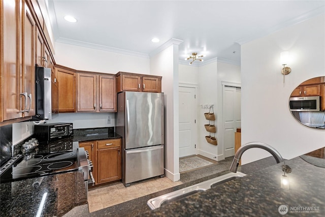 1015 Railroad Ave Unit 405, Bellingham, WA 98225 - kitchen featuring appliances with stainless steel finishes, ornamental molding, brown cabinetry, dark stone countertops, and recessed lighting