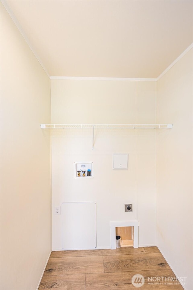 washroom with ornamental molding, washer hookup, wood finished floors, laundry area, and electric dryer hookup