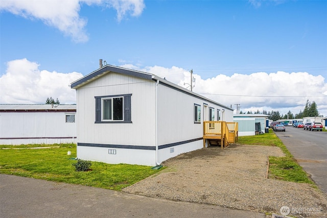 view of home's exterior with a yard and crawl space