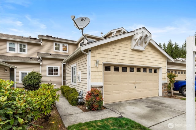 view of front of house featuring concrete driveway and an attached garage