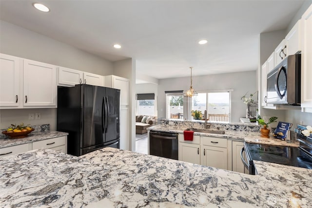 kitchen with stainless steel microwave, freestanding refrigerator, a sink, dishwasher, and range with electric cooktop