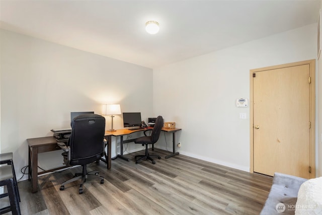 office area with wood finished floors and baseboards