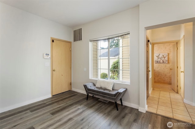 living area with wood finished floors and baseboards