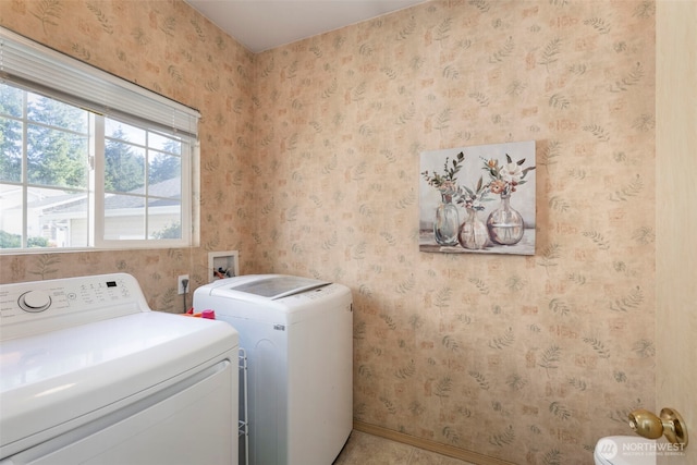 clothes washing area with washer and clothes dryer