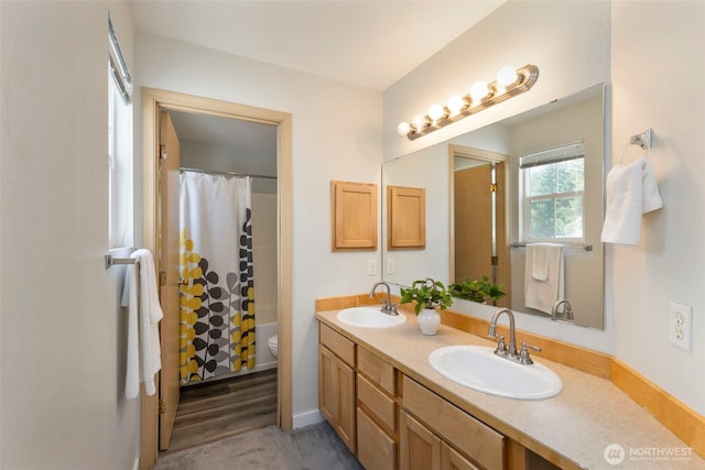 full bathroom with toilet, double vanity, and a shower with shower curtain