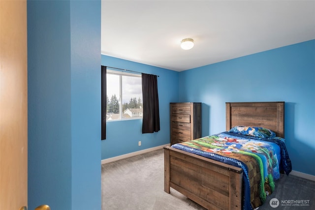carpeted bedroom featuring baseboards