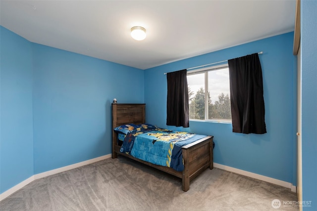 bedroom featuring carpet and baseboards