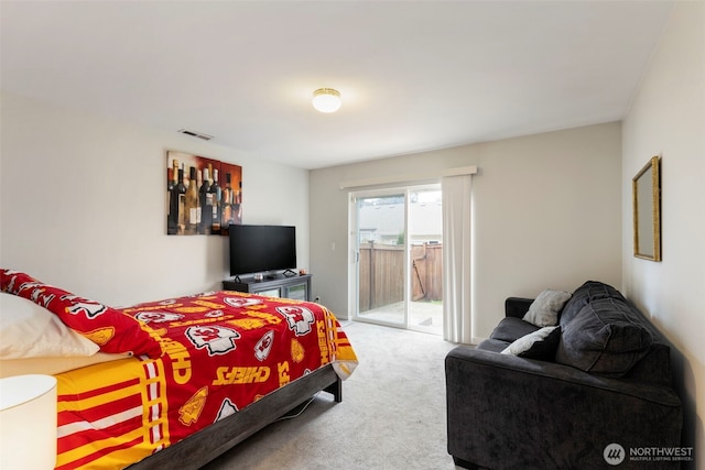 bedroom with access to outside and carpet floors