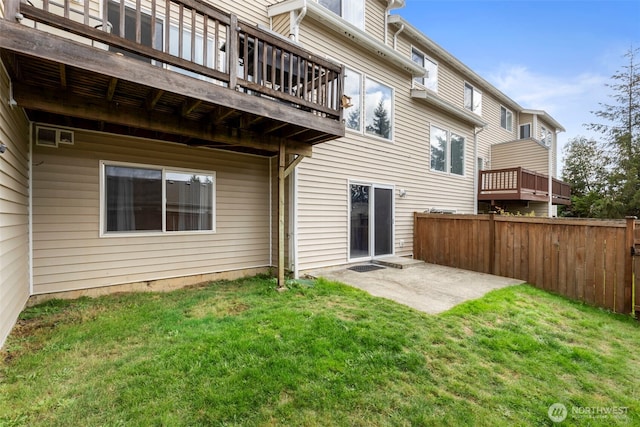 back of house featuring a patio and a wooden deck
