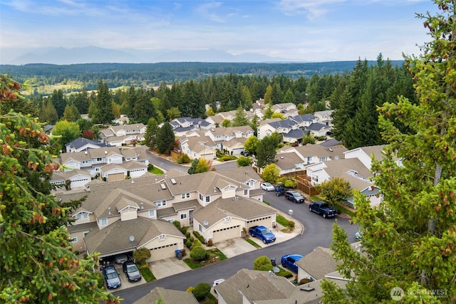 aerial view of residential area featuring a heavily wooded area