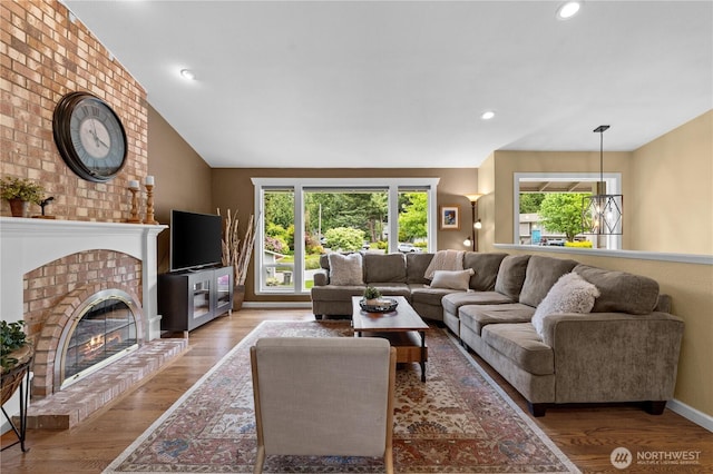 10811 164th Pl NE, Redmond, WA 98052 - living area featuring healthy amount of natural light, light wood-type flooring, a brick fireplace, recessed lighting, and baseboards
