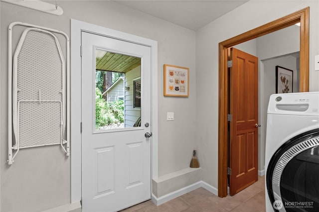 10811 164th Pl NE, Redmond, WA 98052 - washroom featuring washer / dryer, light tile patterned floors, and baseboards