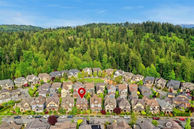 aerial perspective of suburban area featuring a heavily wooded area