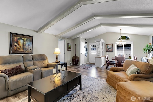 living area with baseboards, a chandelier, wood finished floors, and lofted ceiling