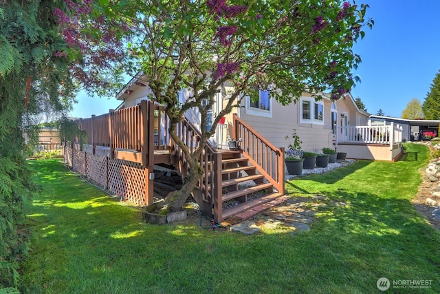 rear view of house with a yard and a deck
