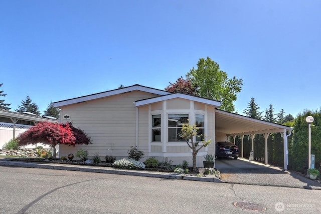 view of front facade featuring aphalt driveway and a carport