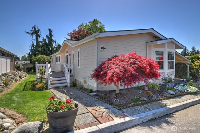 view of property exterior featuring a wooden deck and a lawn