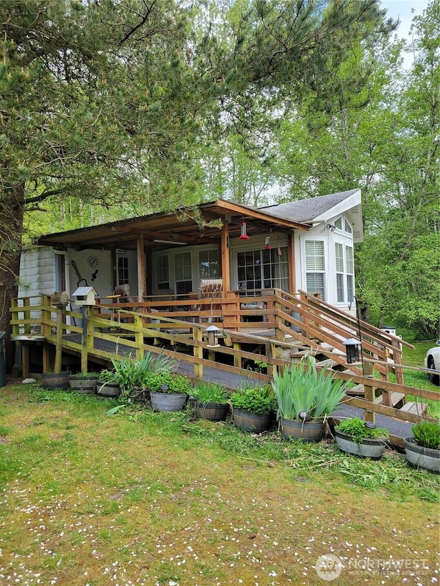 exterior space with a lawn and a deck