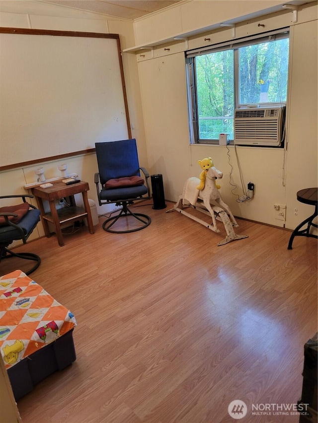 interior space featuring cooling unit and wood finished floors
