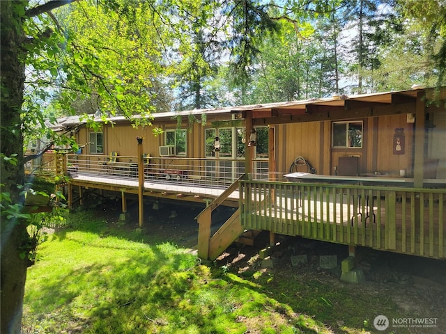 rear view of property featuring a deck