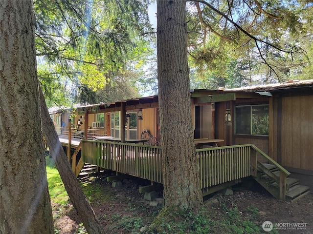 rear view of property featuring a deck
