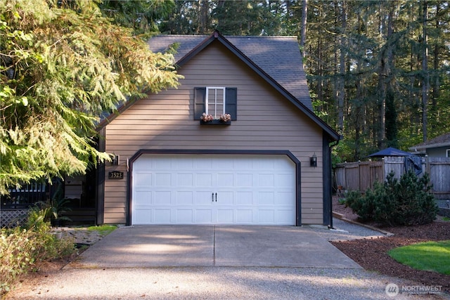 detached garage featuring fence