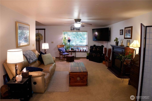 living room featuring carpet flooring and a ceiling fan