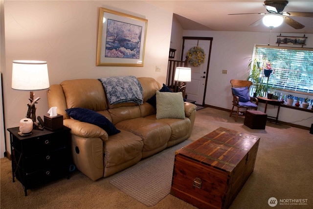 carpeted living room with ceiling fan and baseboards