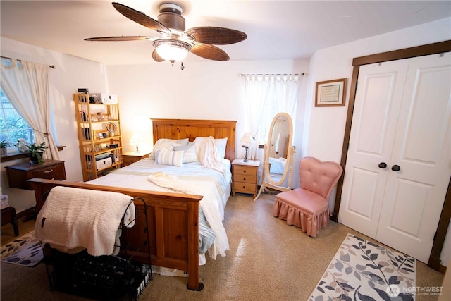 bedroom with multiple windows, a closet, ceiling fan, and light colored carpet
