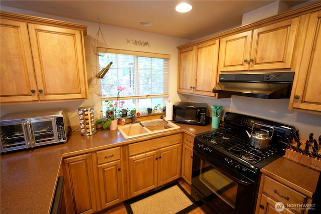 kitchen featuring black appliances, under cabinet range hood, a sink, and recessed lighting