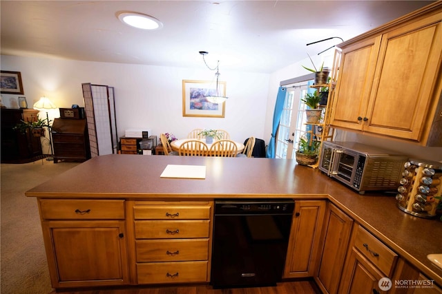 kitchen with a peninsula, dishwasher, brown cabinets, and hanging light fixtures