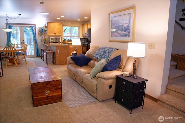 living area with light colored carpet, stairs, recessed lighting, and french doors