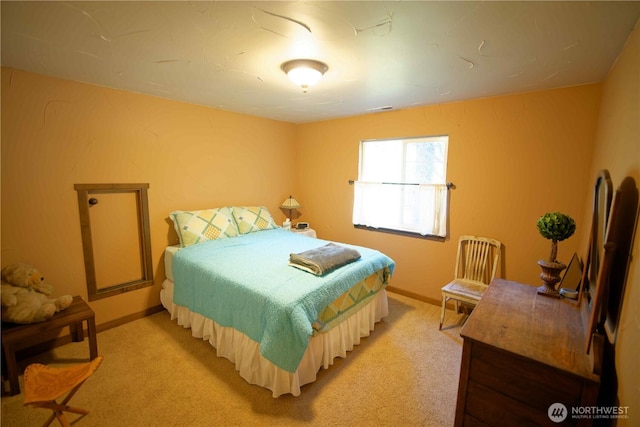 bedroom with light carpet and baseboards